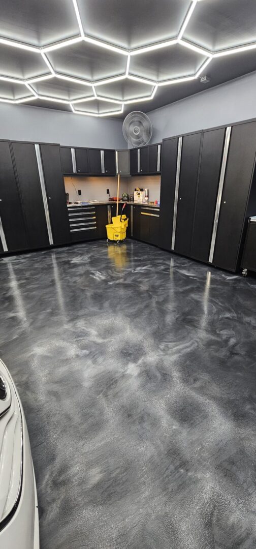 A garage floor with black and silver metallic paint.